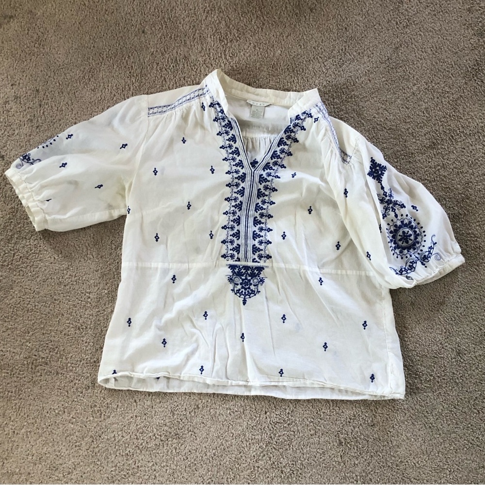 White tunic with blue embroidery details